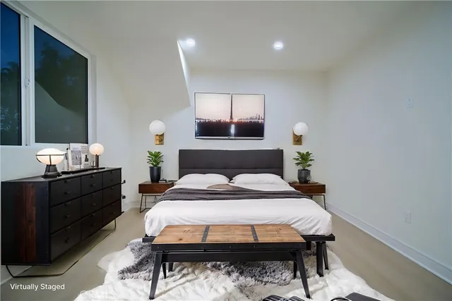 a bedroom with a bed and a flat screen tv