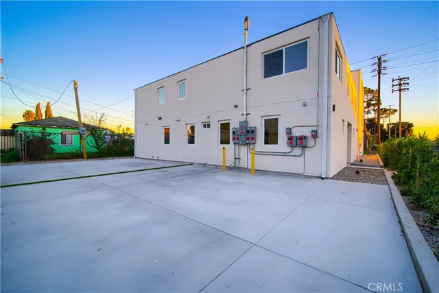 a bedroom with a bed a chandelier and a window