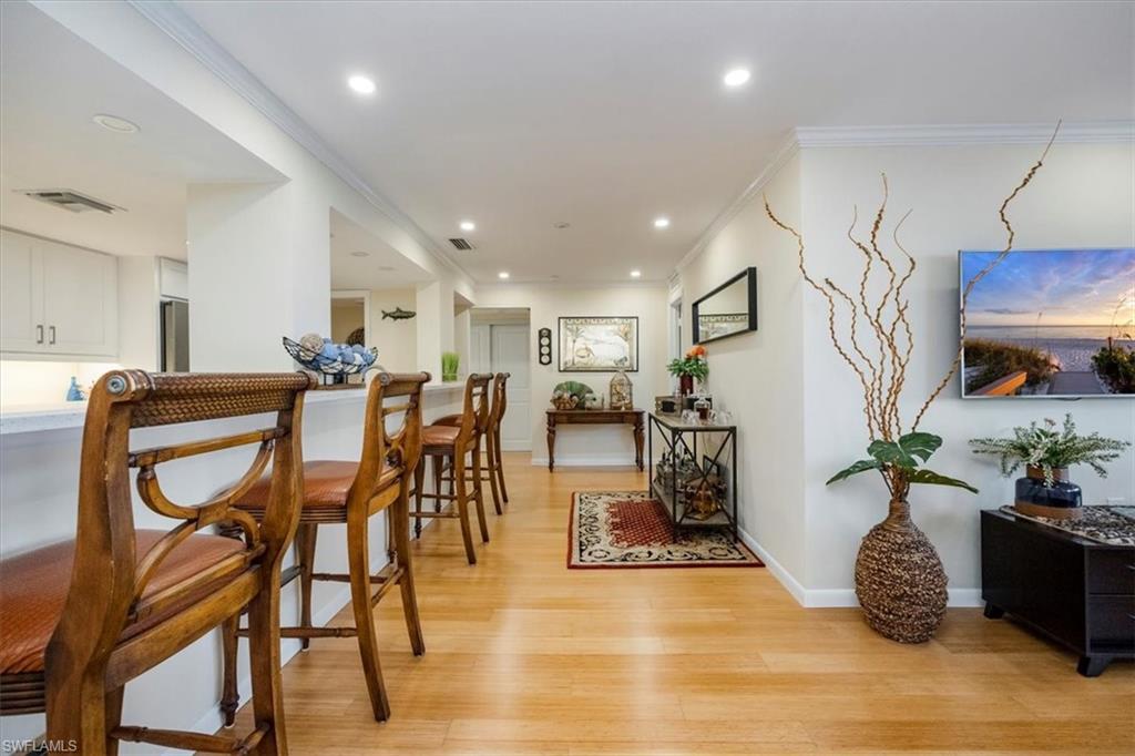 1900 Clifford Street, Unit 301 Fort Myers, FL 33901 - Photo 20 of 35 Dining space featuring light wood-style flooring, crown molding, and recessed lighting