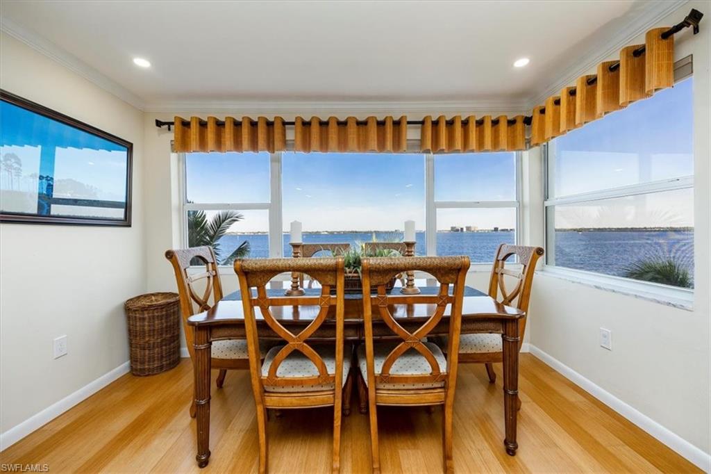 1900 Clifford Street, Unit 301 Fort Myers, FL 33901 - Photo 26 of 35 Dining space featuring light wood-style floors, ornamental molding, recessed lighting, and a water view