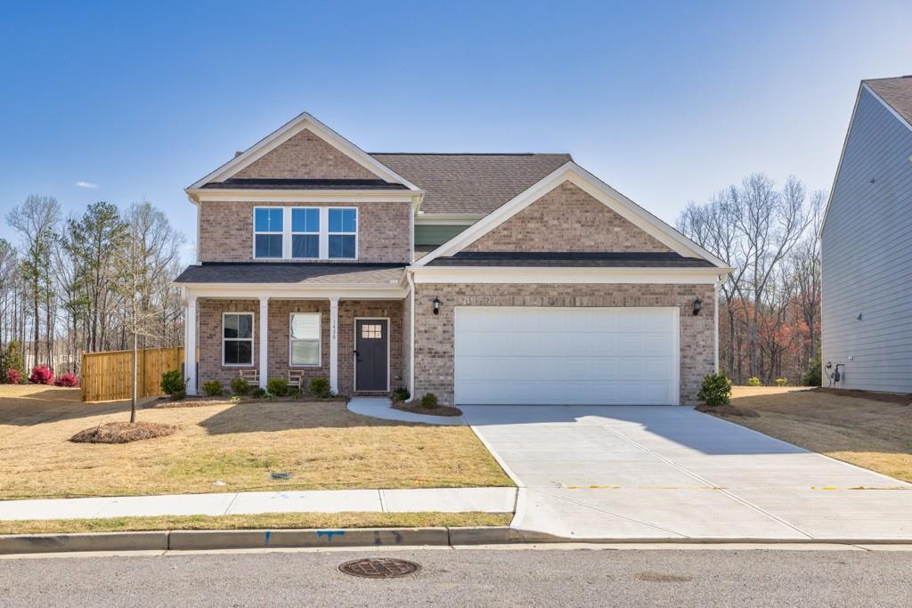 a front view of a house with a yard