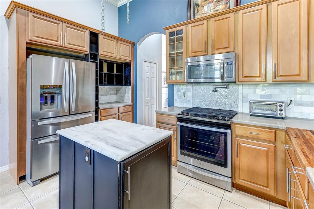 918 Algare Loop Windermere, FL 34786 - Photo 27 of 73 a kitchen with stainless steel appliances granite countertop a refrigerator and a sink