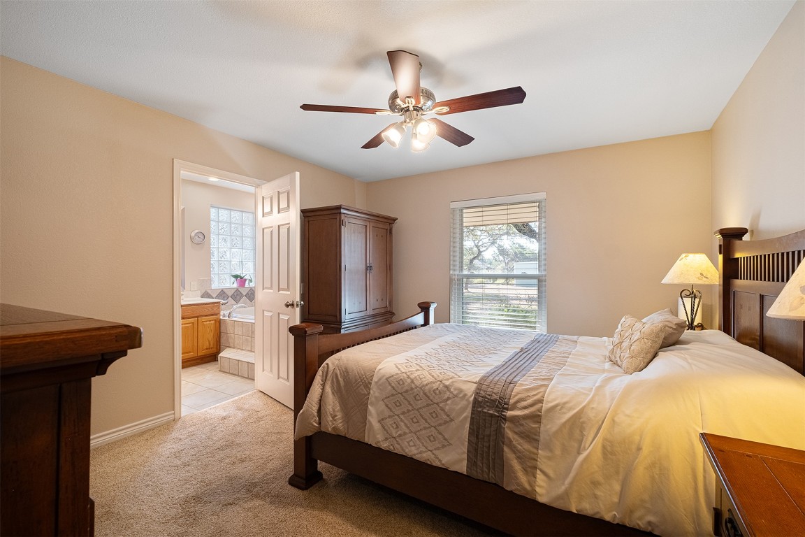 280 Sunset Terrace Cedar Park, TX 78613 - Photo 15 of 38 a bedroom with a bed and a chandelier fan