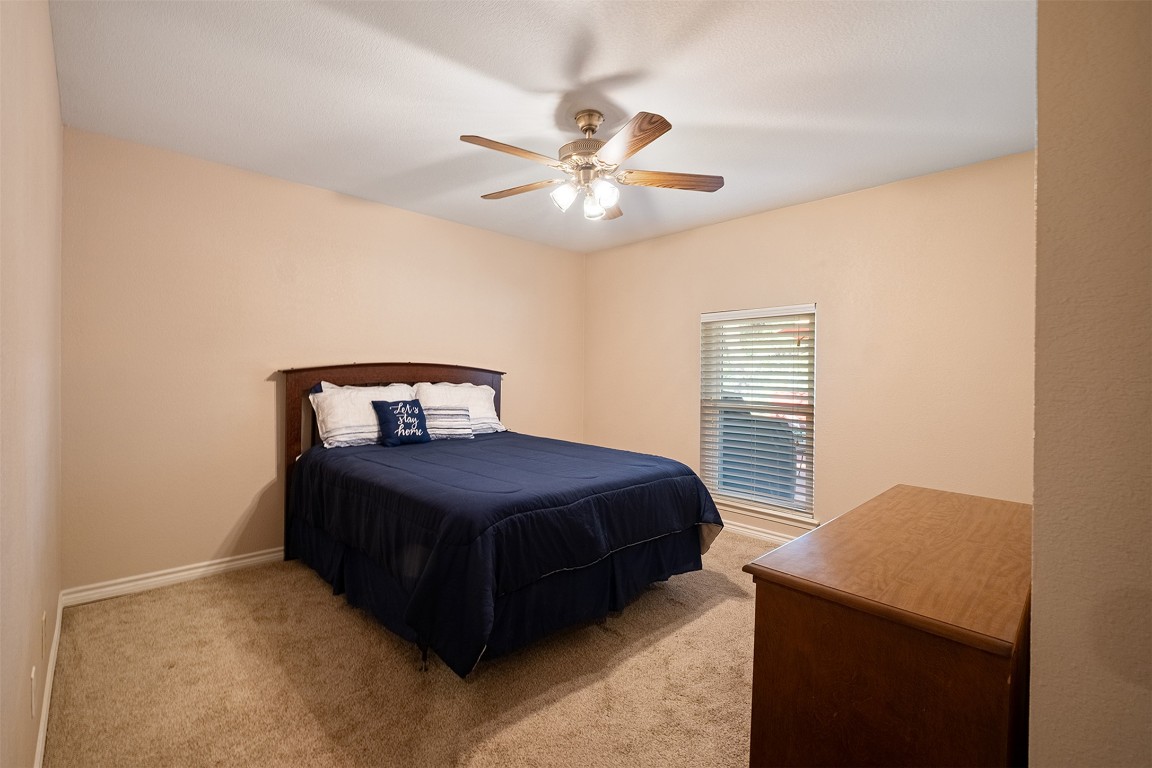 280 Sunset Terrace Cedar Park, TX 78613 - Photo 19 of 38 a bedroom with a bed and a ceiling fan