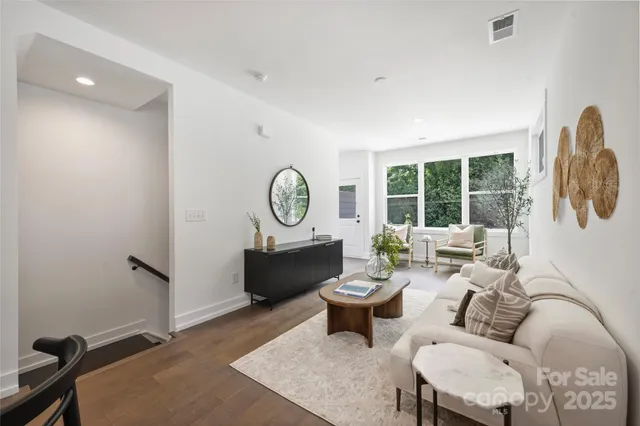 a living room with furniture a rug and a large window