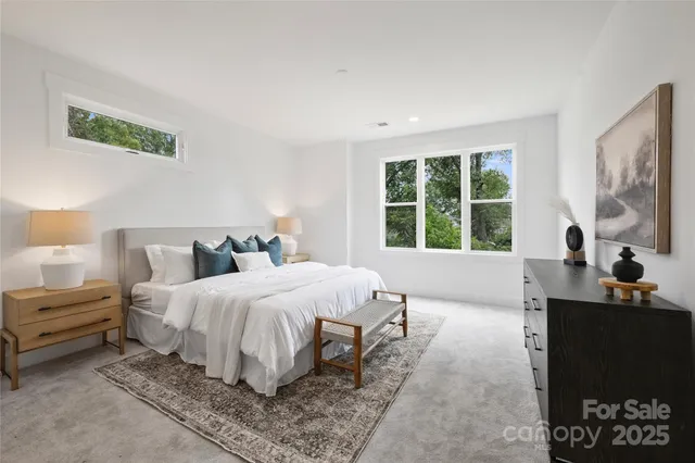 a bedroom with bed and a large window