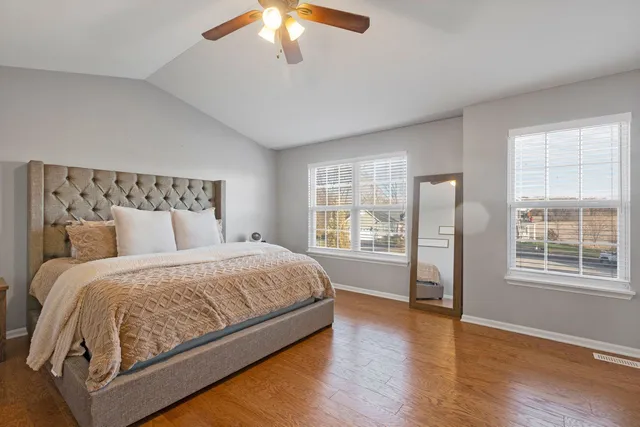 a bedroom with a large bed and a large window