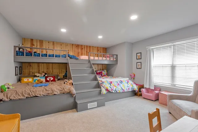 a bedroom with furniture toys and a window