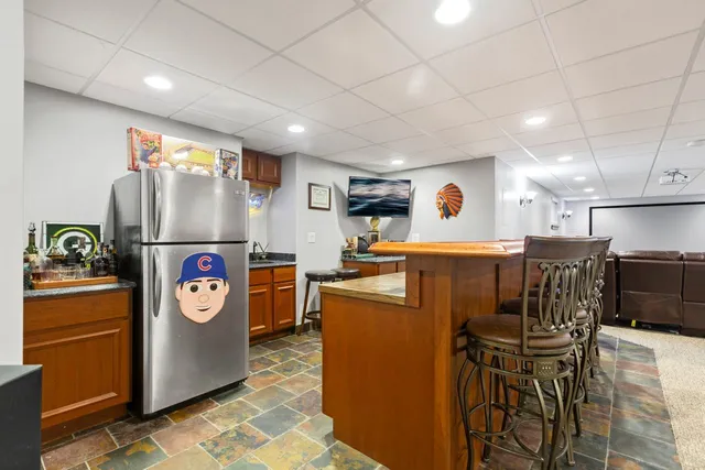 a kitchen with refrigerator and furniture