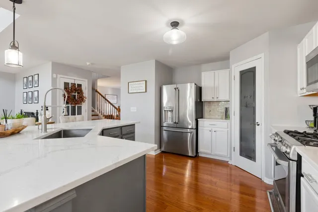a kitchen with stainless steel appliances a refrigerator and a stove