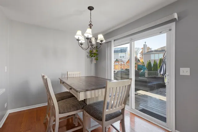 a view of a dining room with furniture wooden floor and chandelier