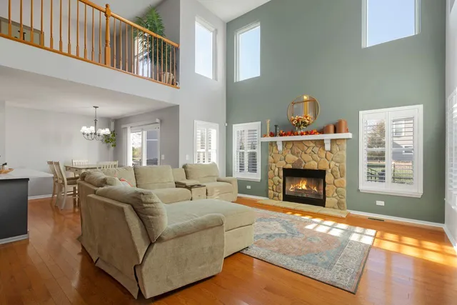 a living room with furniture large window and a fireplace