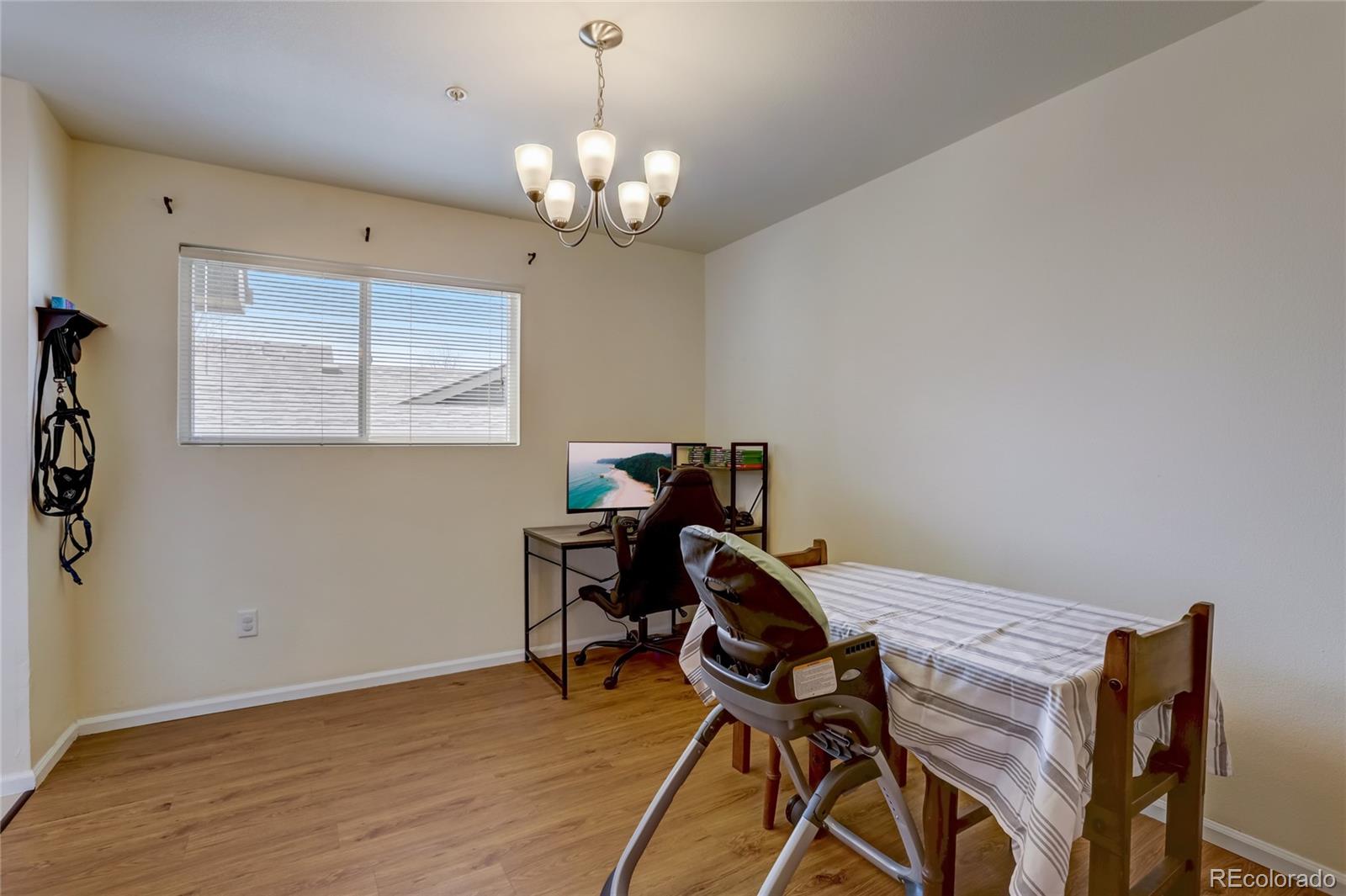 2900 Purcell Street, Unit O4 Brighton, CO 80601 - Photo 11 of 28 a view of a workspace with furniture and a chandelier