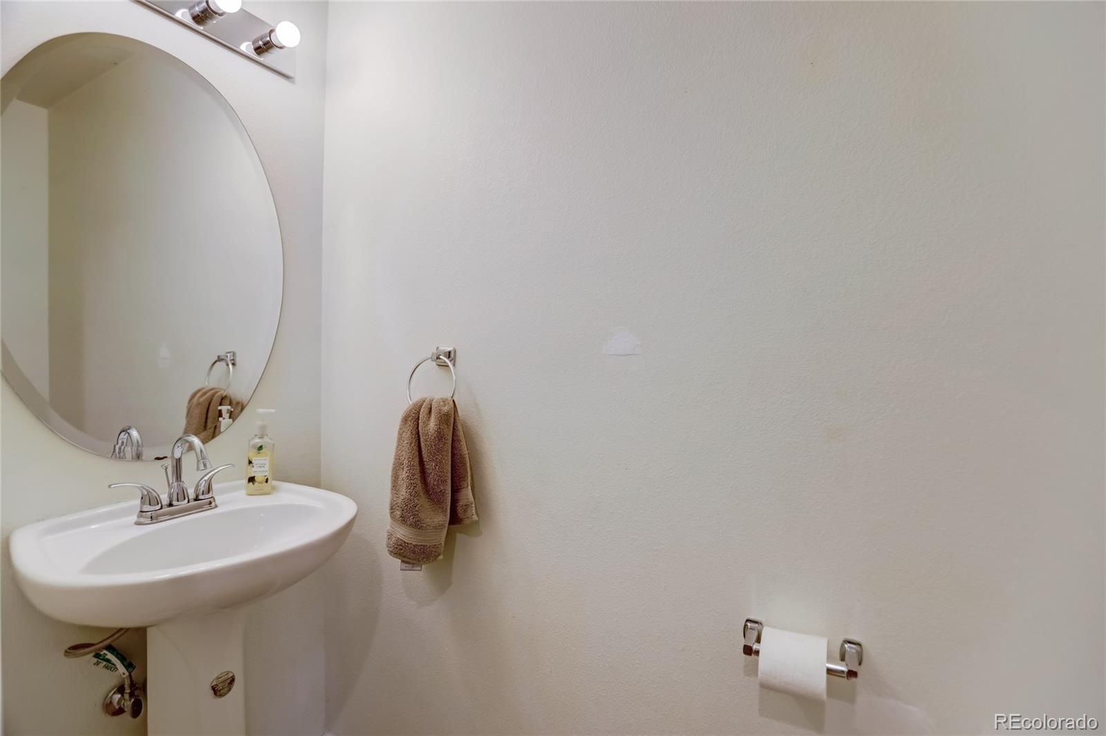 2900 Purcell Street, Unit O4 Brighton, CO 80601 - Photo 13 of 28 a bathroom with a sink and mirror