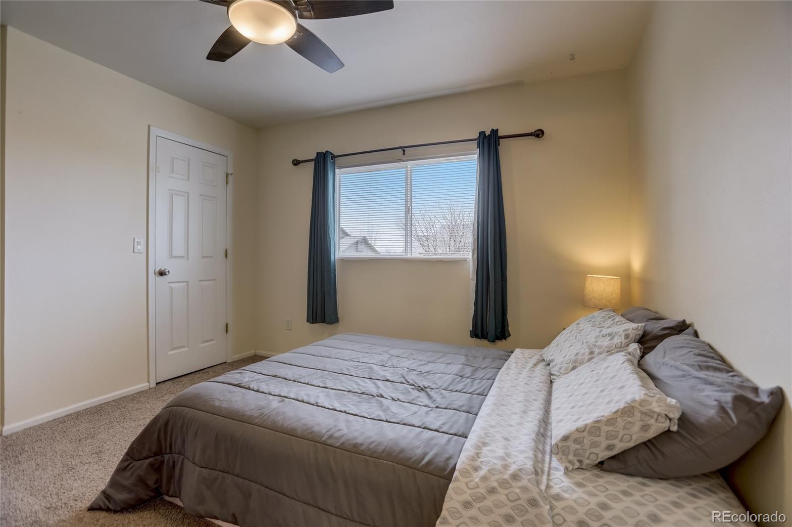 2900 Purcell Street, Unit O4 Brighton, CO 80601 - Photo 15 of 28 a bedroom with a bed and a chandelier