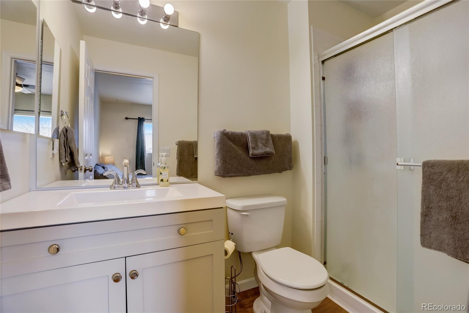 2900 Purcell Street, Unit O4 Brighton, CO 80601 - Photo 17 of 28 a bathroom with a sink a toilet a shower and a mirror