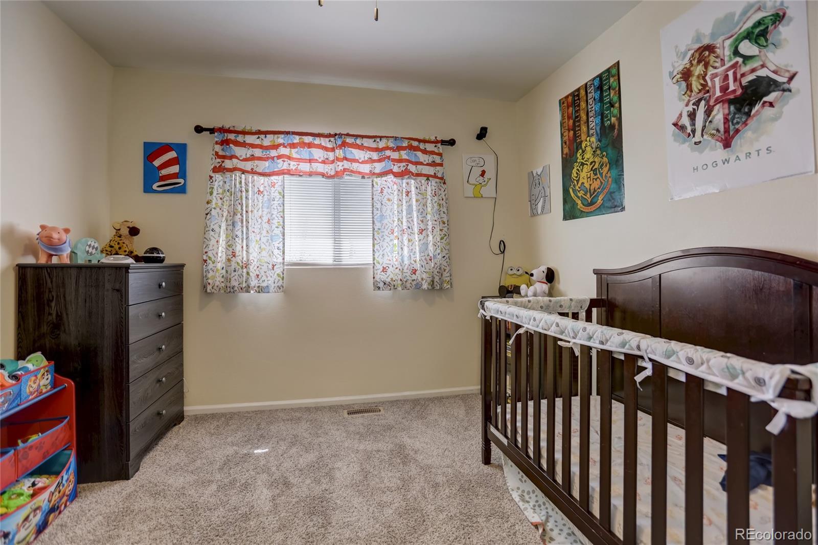 2900 Purcell Street, Unit O4 Brighton, CO 80601 - Photo 18 of 28 a bedroom with furniture and a window