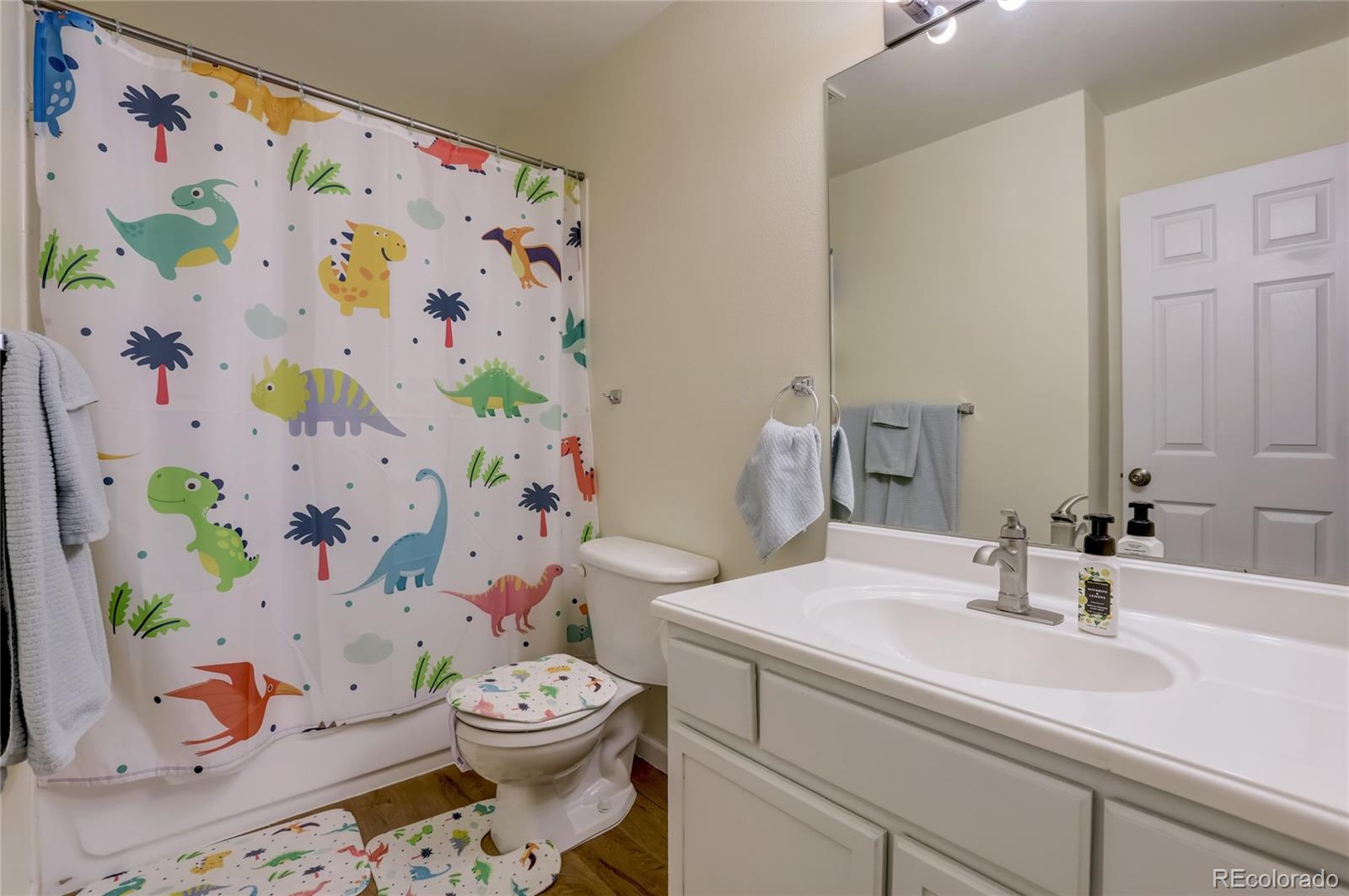 2900 Purcell Street, Unit O4 Brighton, CO 80601 - Photo 20 of 28 a bathroom with a sink a toilet and curtain
