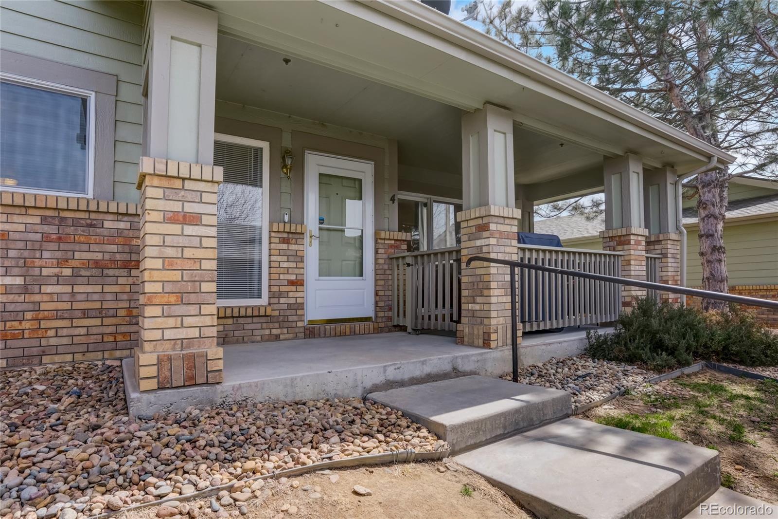 2900 Purcell Street, Unit O4 Brighton, CO 80601 - Photo 2 of 28 a view of a house with a small yard and wooden floor and fence
