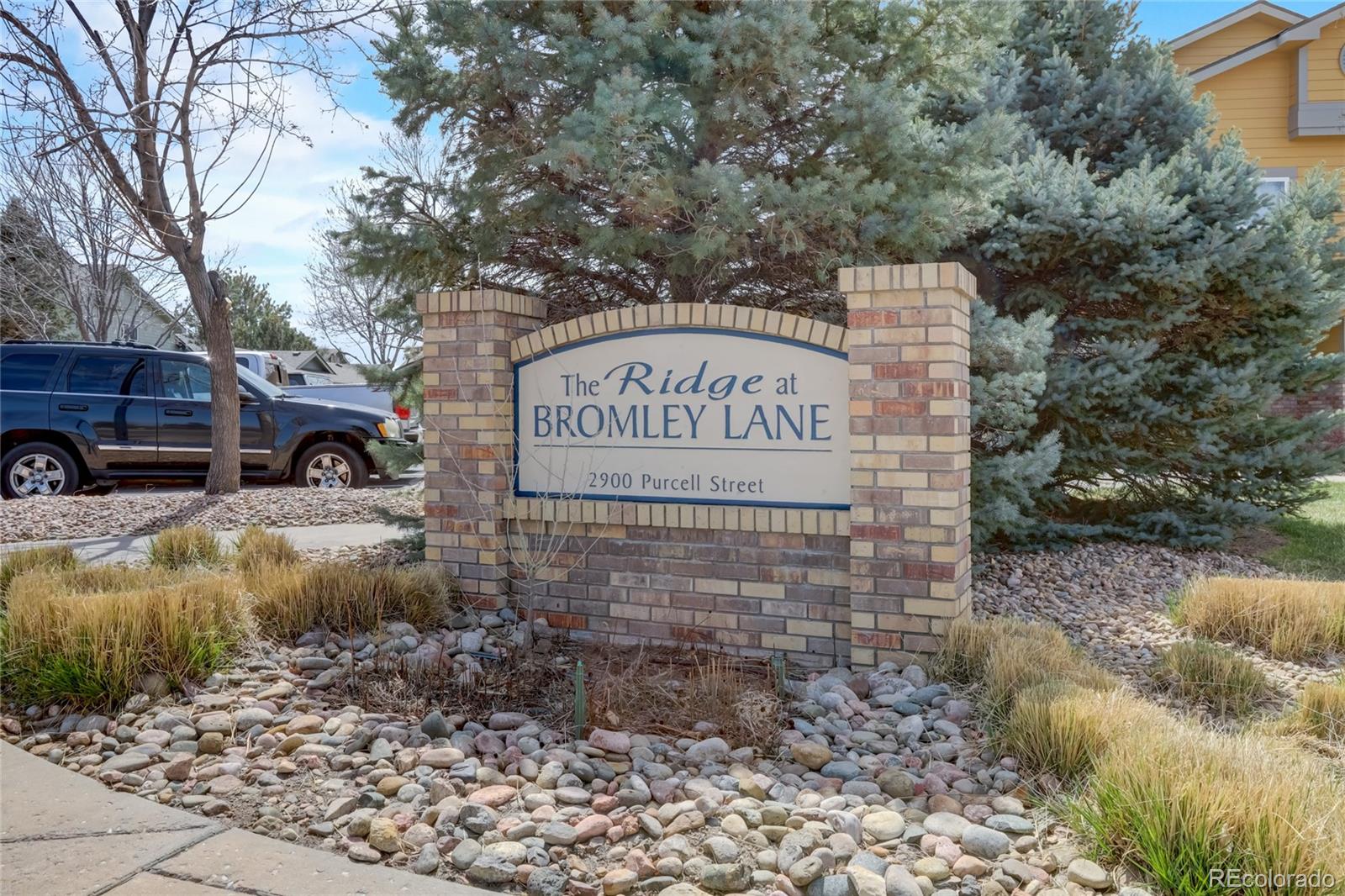 2900 Purcell Street, Unit O4 Brighton, CO 80601 - Photo 27 of 28 a view of street sign under a large tree