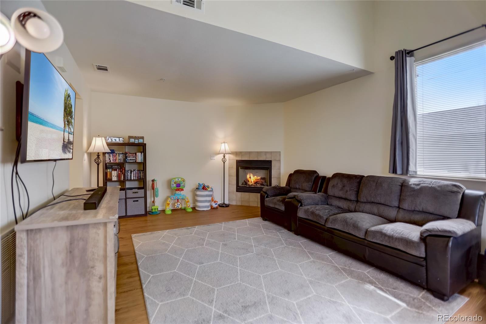 2900 Purcell Street, Unit O4 Brighton, CO 80601 - Photo 3 of 28 a living room with furniture and a flat screen tv