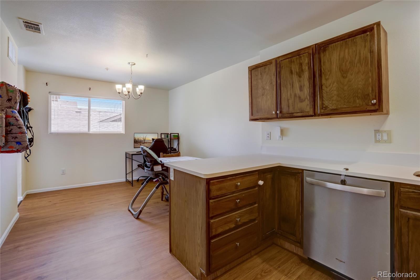2900 Purcell Street, Unit O4 Brighton, CO 80601 - Photo 10 of 28 a view of a kitchen with sink microwave and cabinets