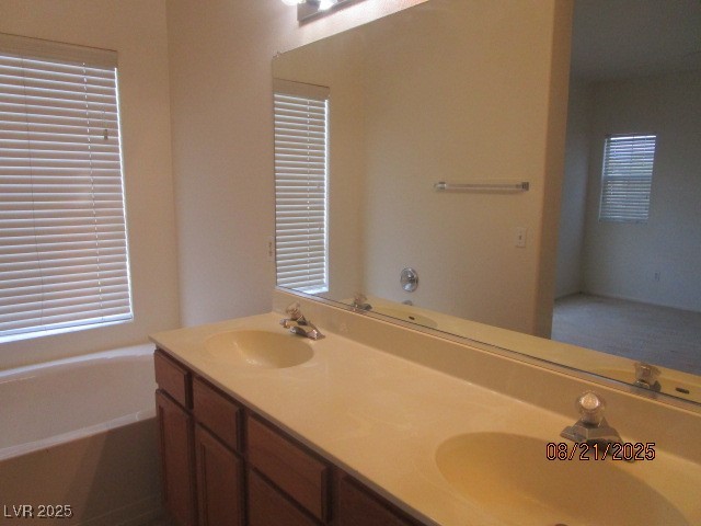 667 Solitude Point Avenue Henderson, NV 89012 - Photo 15 of 22 Full bathroom featuring double vanity and a bath