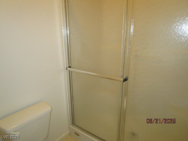 667 Solitude Point Avenue Henderson, NV 89012 - Photo 16 of 22 Bathroom featuring toilet and a shower stall