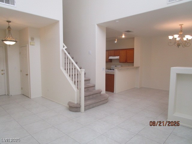 667 Solitude Point Avenue Henderson, NV 89012 - Photo 2 of 22 Stairs with a chandelier and tile patterned floors