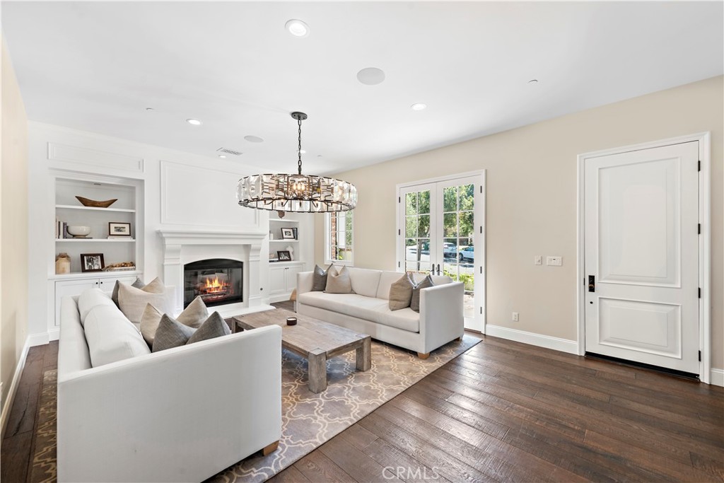 5 Connor Court Ladera Ranch, CA 92694 - Photo 11 of 63 a living room with furniture a chandelier and a fireplace