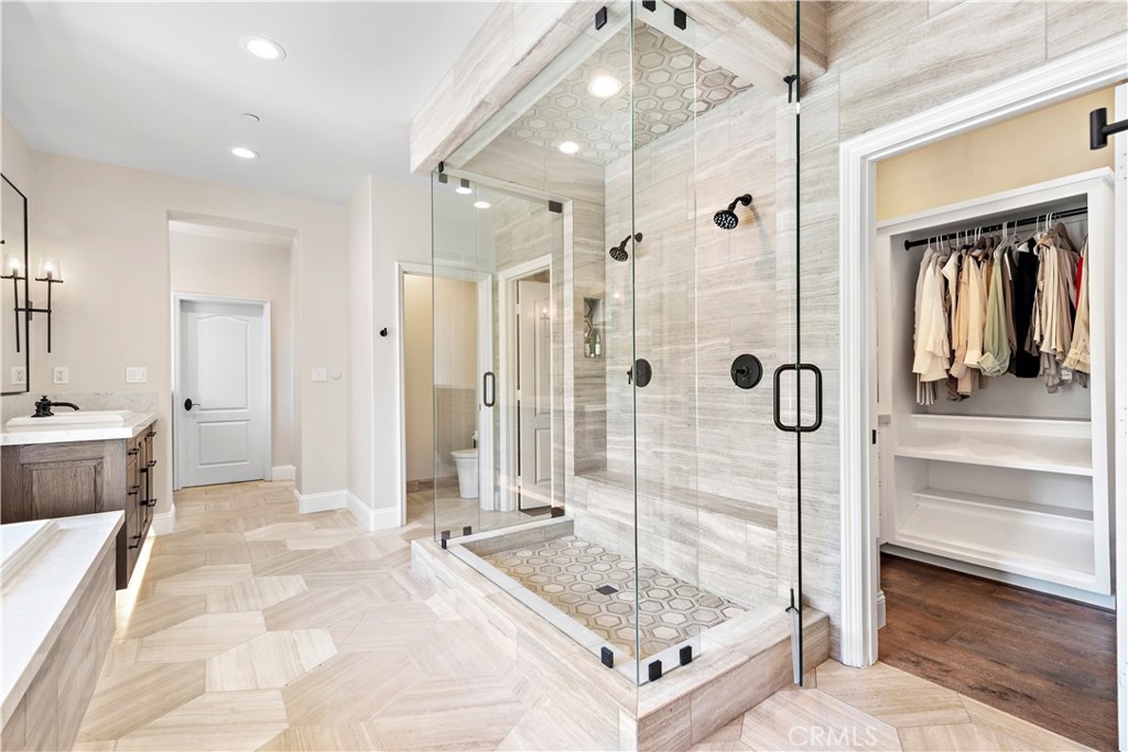 5 Connor Court Ladera Ranch, CA 92694 - Photo 30 of 63 a bathroom with a tub shower and mirror