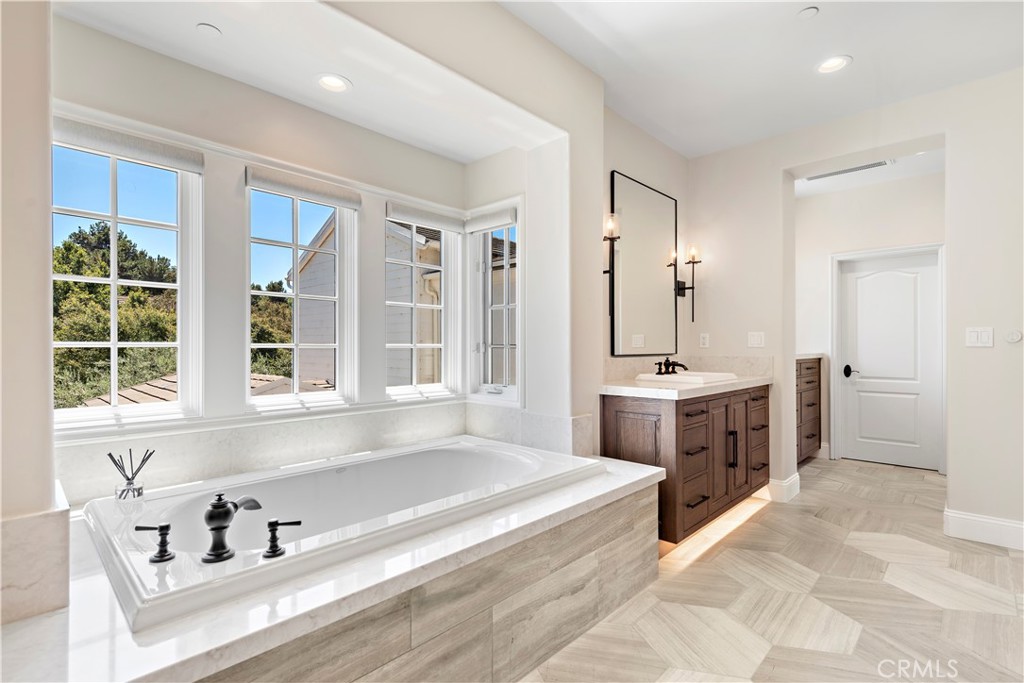 5 Connor Court Ladera Ranch, CA 92694 - Photo 31 of 63 a spacious bathroom with a tub sink and mirror