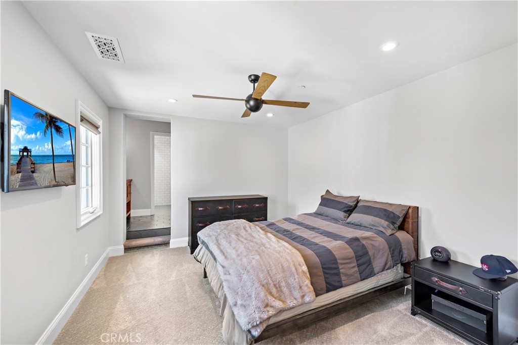 5 Connor Court Ladera Ranch, CA 92694 - Photo 35 of 63 a bedroom with bed and a chandelier