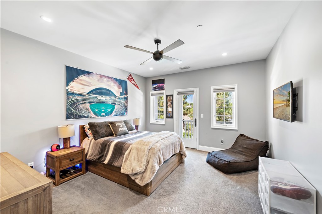 5 Connor Court Ladera Ranch, CA 92694 - Photo 36 of 63 a spacious bedroom with a bed a couch and a large window