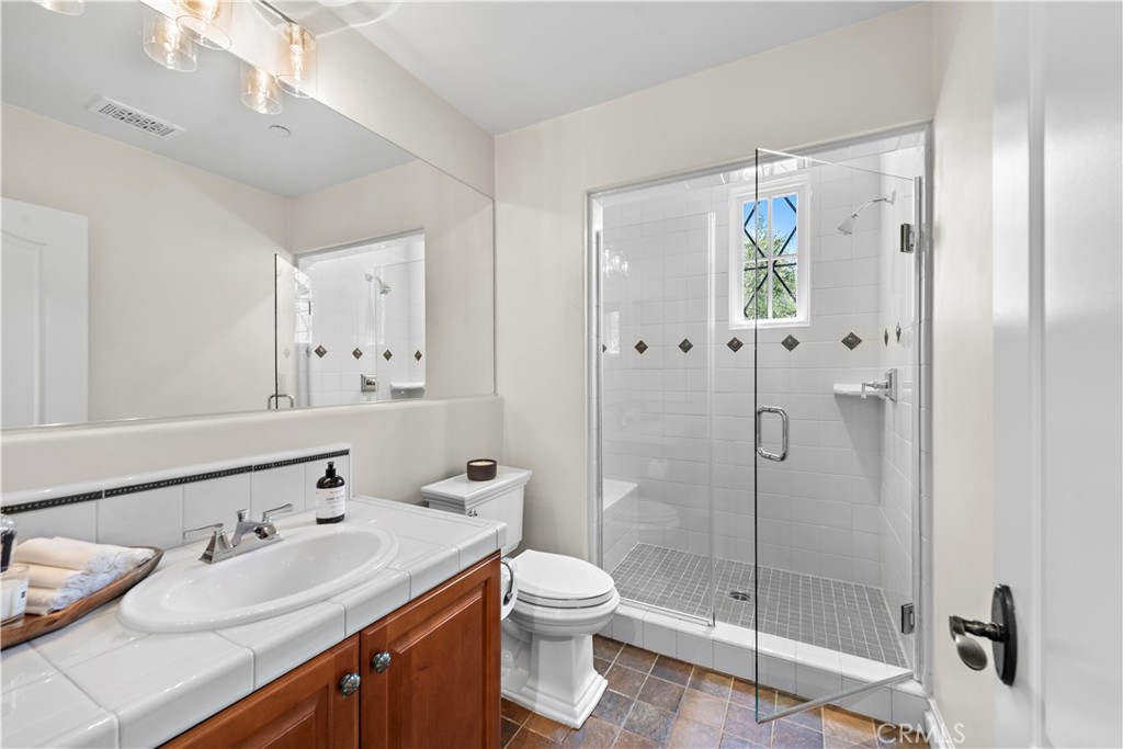 5 Connor Court Ladera Ranch, CA 92694 - Photo 37 of 63 a bathroom with a double vanity sink toilet and shower