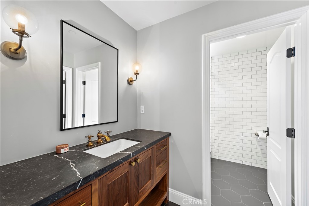 5 Connor Court Ladera Ranch, CA 92694 - Photo 38 of 63 a bathroom with a granite countertop sink and a mirror