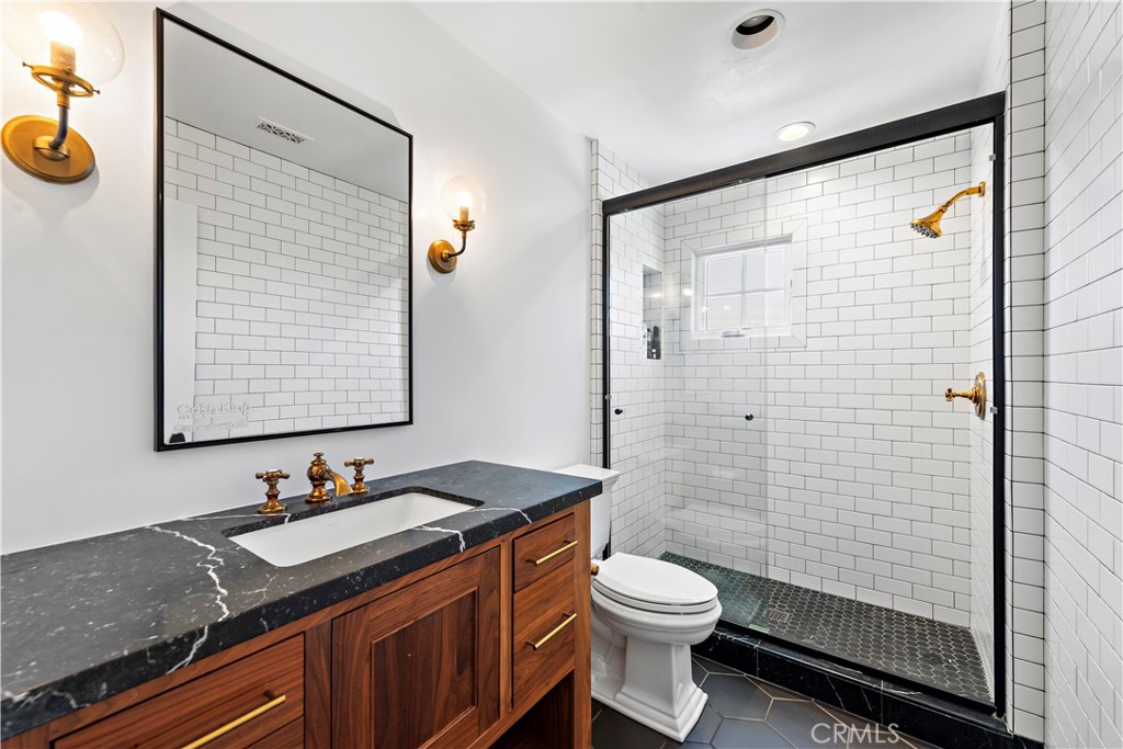 5 Connor Court Ladera Ranch, CA 92694 - Photo 39 of 63 a bathroom with a granite countertop sink toilet and shower