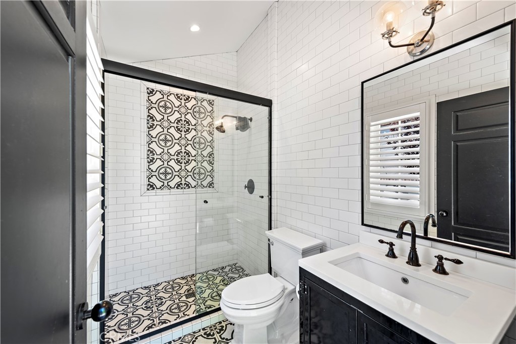 5 Connor Court Ladera Ranch, CA 92694 - Photo 41 of 63 a bathroom with a sink a toilet a mirror and shower