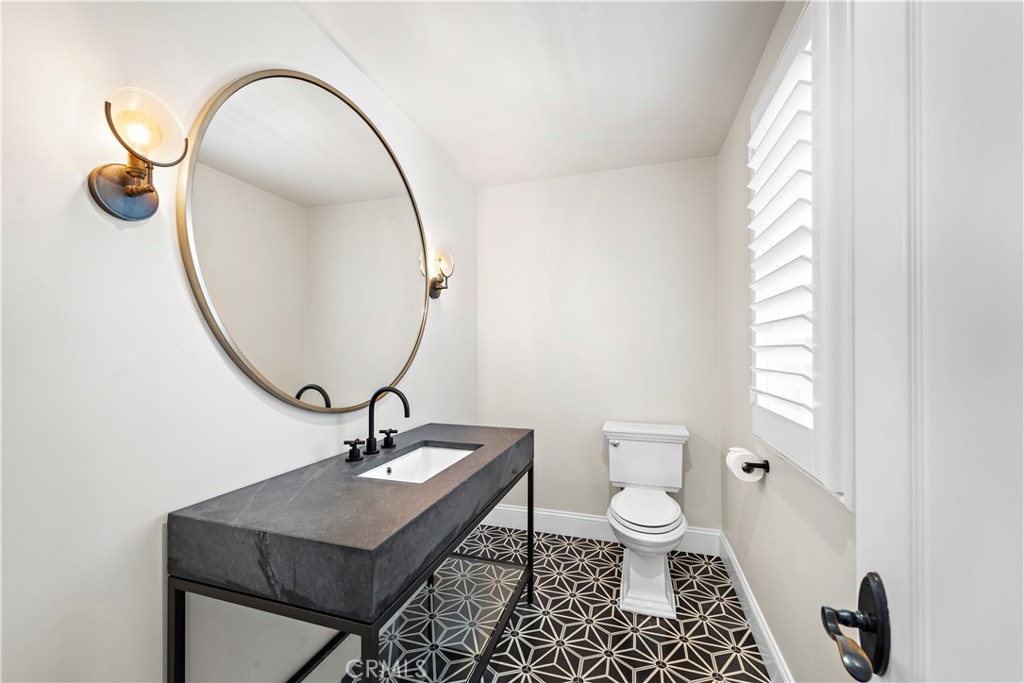 5 Connor Court Ladera Ranch, CA 92694 - Photo 42 of 63 a bathroom with a toilet a sink and a mirror