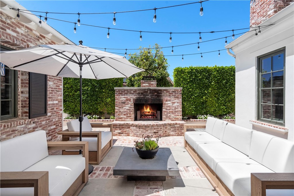 5 Connor Court Ladera Ranch, CA 92694 - Photo 9 of 63 a view of a patio with couches table and chairs under an umbrella