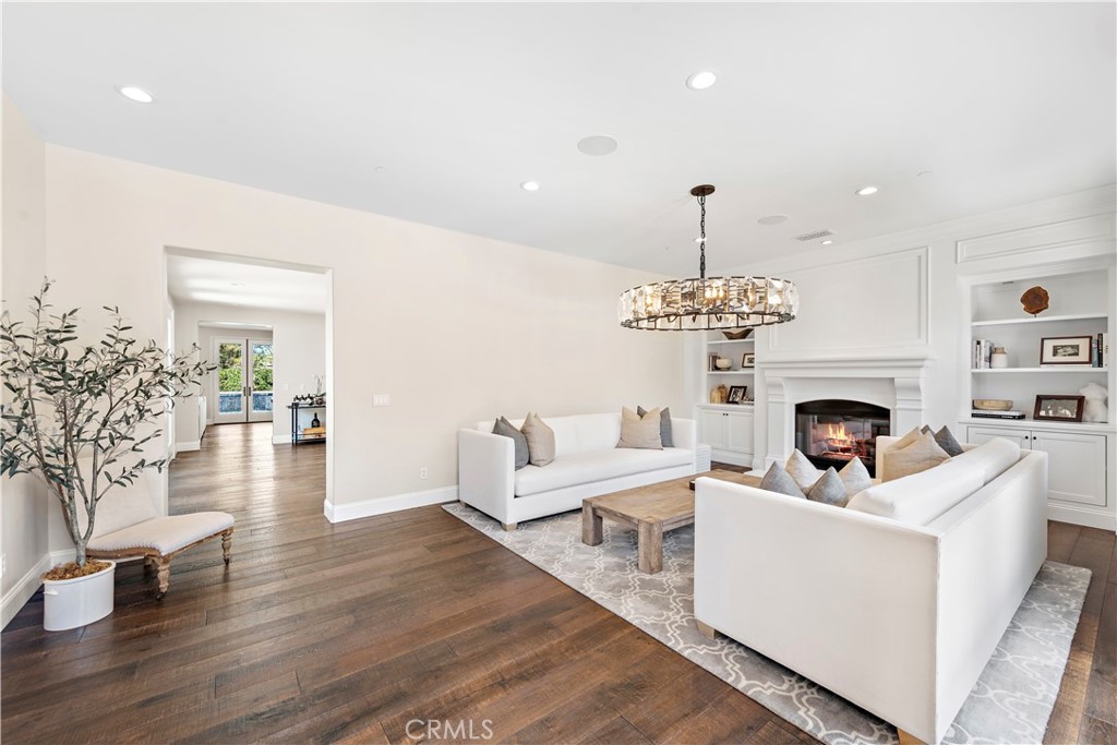 5 Connor Court Ladera Ranch, CA 92694 - Photo 10 of 63 a living room with furniture a fireplace and a chandelier