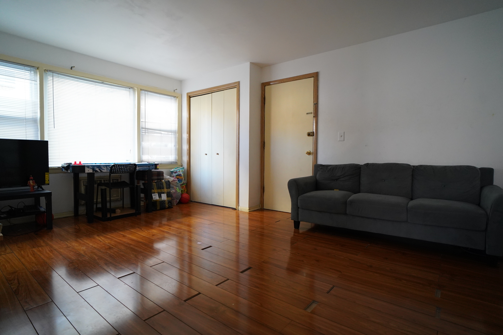 8518 West Rascher Avenue, Unit 2 Chicago, IL 60656 - Photo 2 of 8 a living room with furniture and a flat screen tv