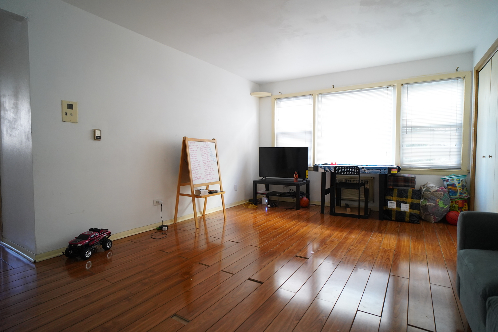 8518 West Rascher Avenue, Unit 2 Chicago, IL 60656 - Photo 3 of 8 a view of a livingroom with furniture and a flat screen tv