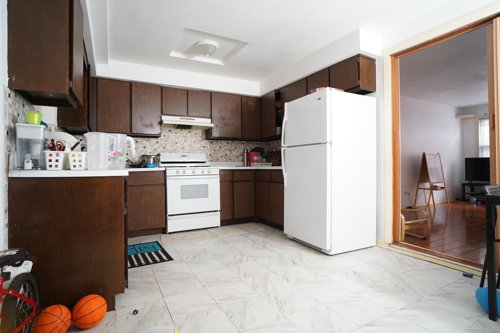 8518 West Rascher Avenue, Unit 2 Chicago, IL 60656 - Photo 5 of 8 a kitchen with stainless steel appliances a sink a stove a refrigerator and cabinets
