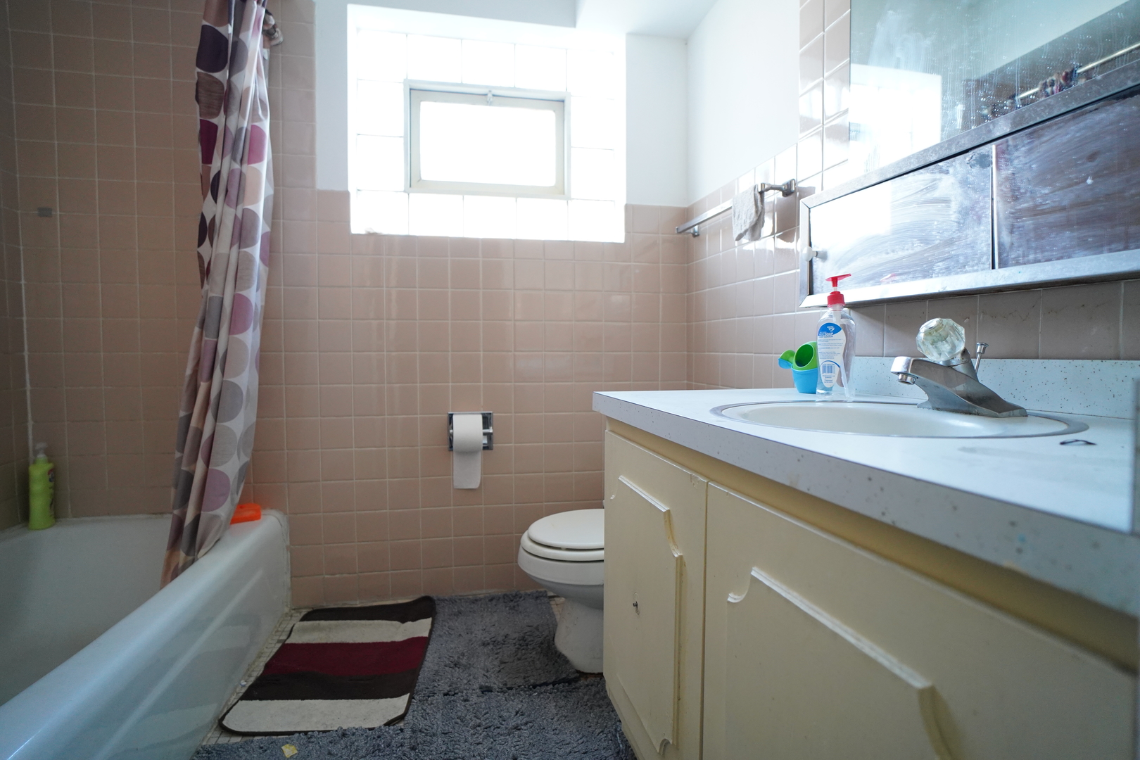 8518 West Rascher Avenue, Unit 2 Chicago, IL 60656 - Photo 7 of 8 a bathroom with a sink a toilet and shower