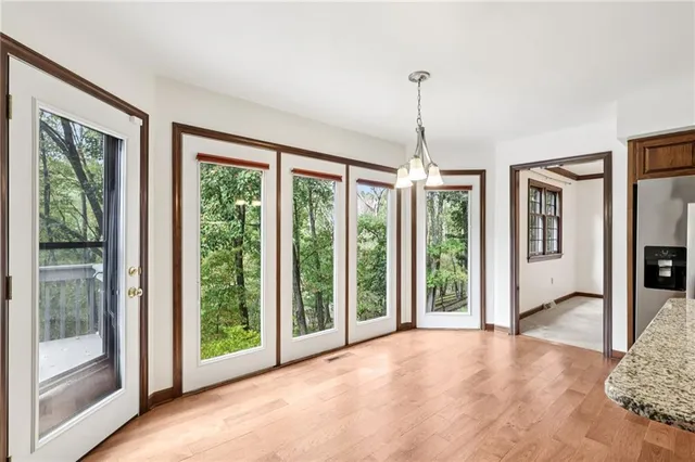 a view of an empty room with glass door and balcony