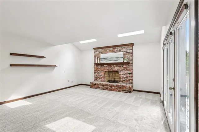 a view of an empty room with a fireplace