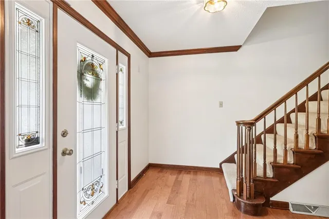 a view of an entryway with wooden floor