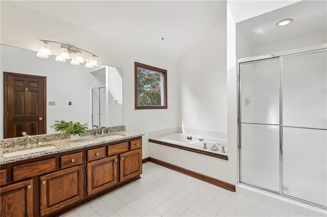 a spacious bathroom with a double vanity sink mirror and double