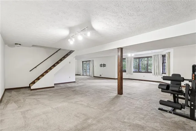 a view of a livingroom with furniture and floor to ceiling window